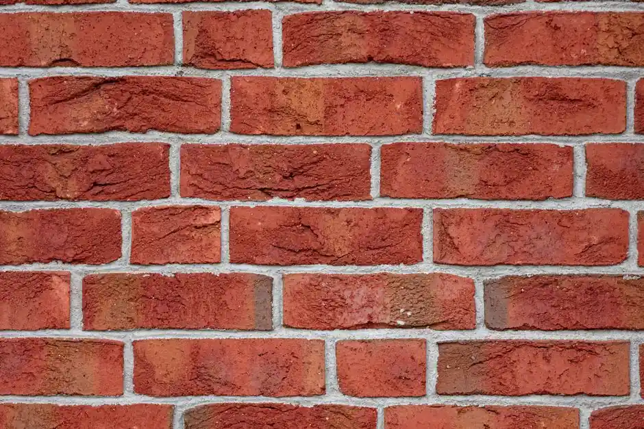 Detailed image of a red brick wall, showcasing texture and urban design pattern.